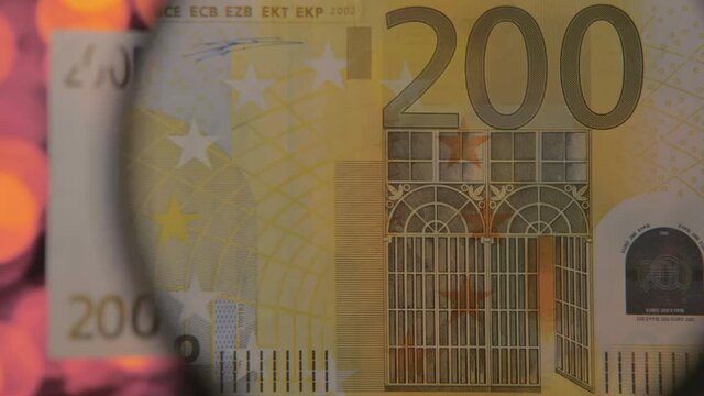 The image on the 200 Euro paper money in banknote on a magnifying glass look