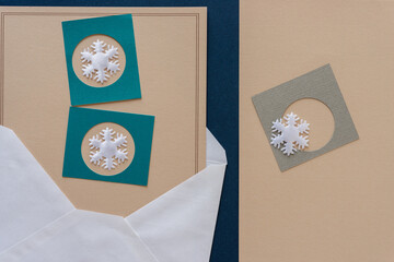 paper background with christmas elements (snowflakes and envelope)