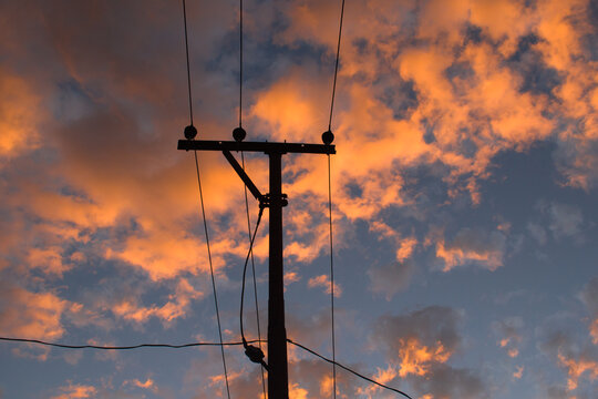 Old electricity pole and beautiful orange clouds