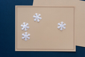 white fabric snowflakes on old stationary with space