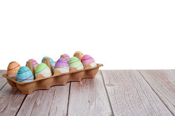 Colorfully painted Easter eggs on wooden table on white background