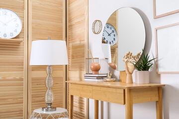 Modern wooden dressing table with mirror and decorative elements indoors