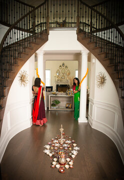 Indian Women decorating home for wedding 