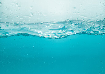 Water waves splash with air bubbles, isolated on the white background. abstract blue water waves on...