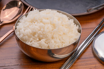 Korean steamed rice in silver cup ready to eat, Korean style