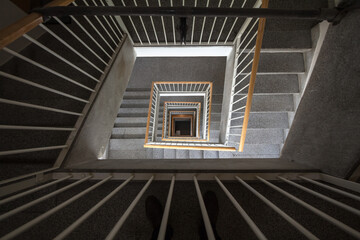 Selective blur on an old staircase, a swirling spiral stairway in a dwelling residential building, seen from above, from the higher floors, with a perspective effect till the bottom. ..