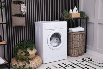 Stylish laundry room interior with washing machine