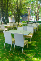 empty wicker table and chair in outdoor restaurant