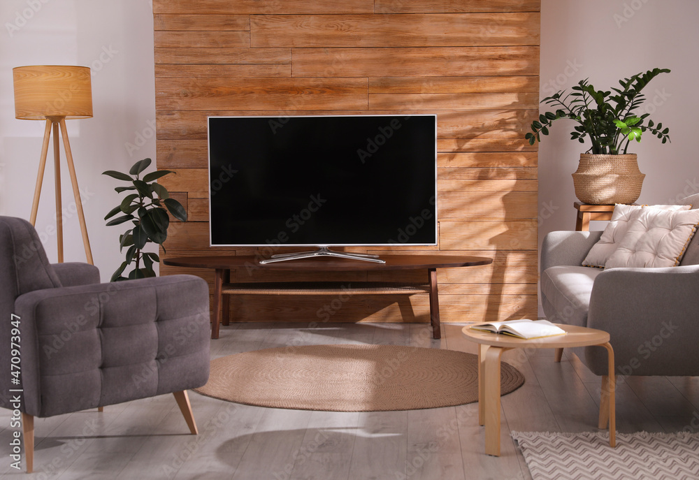 Sticker Stylish living room interior with TV on table and houseplants