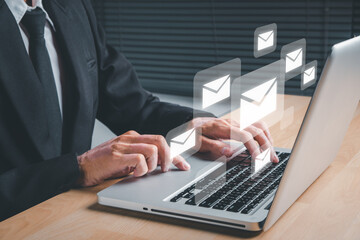 Email and sms marketing concept. Businessman typing on keyboard laptop computer with email icon on screen display, Scheme of direct sales in business, List of clients for mailing.