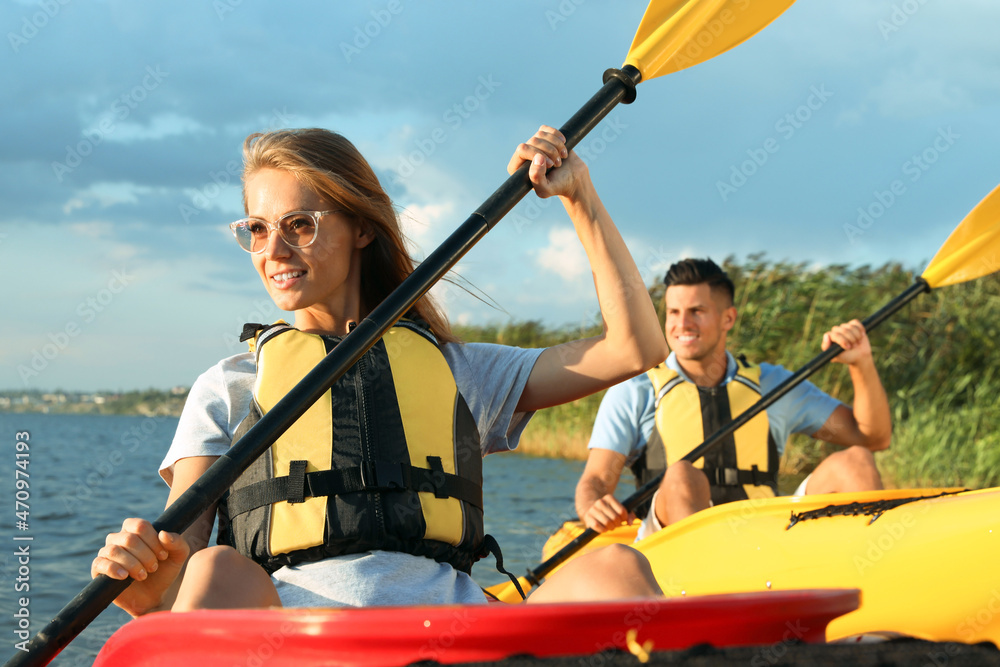 Sticker Couple in life jackets kayaking on river. Summer activity