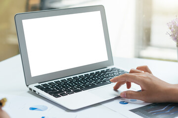 Fototapeta na wymiar Blank screen laptop mock up,Woman typing laptop keyboard.