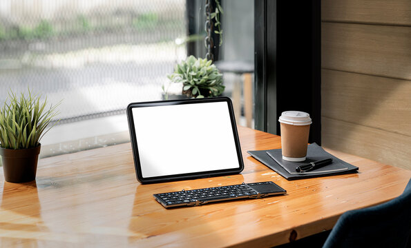 portable tablet on wooden table in living room.