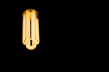 Luminous tubes of a fluorescent lamp on a black background. Selective focus, copy space