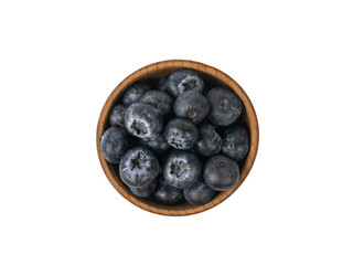 Top view of a wooden bowl with blueberries isolated on a white background.