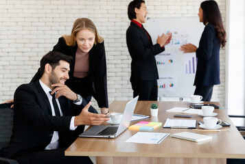 Cheerful Asian colleagues near business people