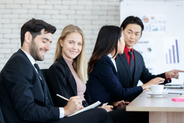 Cheerful multiethnic colleagues in boardroom