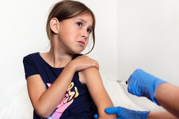 child is afraid of a syringe, the girl yells and does not want to give an injection. Children's...
