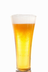 Light beer with foam in a tall transparent beer glass on a white background