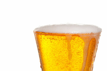 Fragment of a glass goblet with beer on a white background, close-up