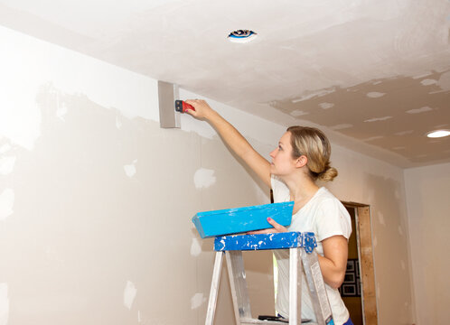 Kitchen Remodel Young Woman Taping Ceiling Joint