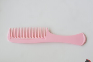 pink hair comb on a white background
