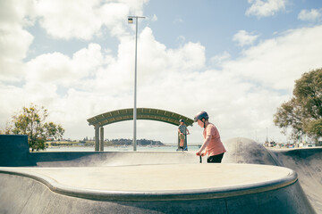 Portland, Victoria Australia- 14 November 2021- Children riding scooters at local skate park