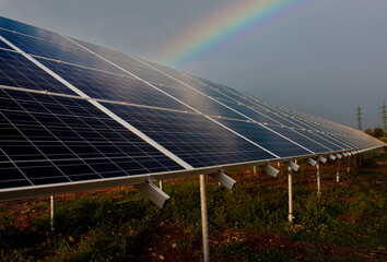 solar panels with rainbows in the background