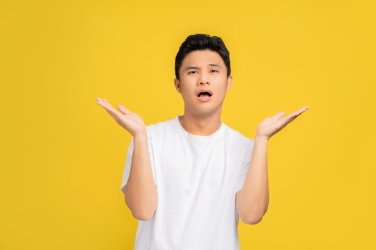 Young handsome man over isolated background clueless and confused expression with arms and hands raised. Doubt concept.