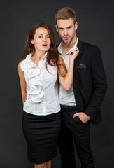 formal man and woman in business look on black background, cooperation