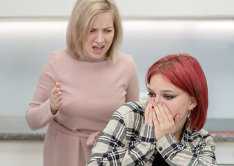 Obraz na płótnie Canvas Family conflict. Angry mother screams at afraid teen daughter