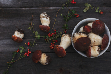 boletus mushrooms and wild berries on an old wooden background