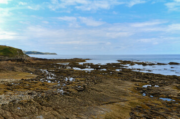 Hills, flat rocks and Ocean in Comillas in the Cantabria region.