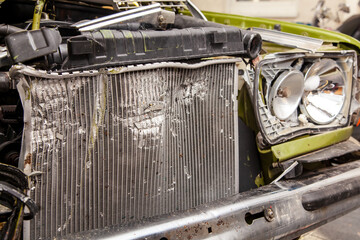 Accident, Car crash collision. Closeup shot of a crashed oldtimer cars front with Vehicle Radiator....