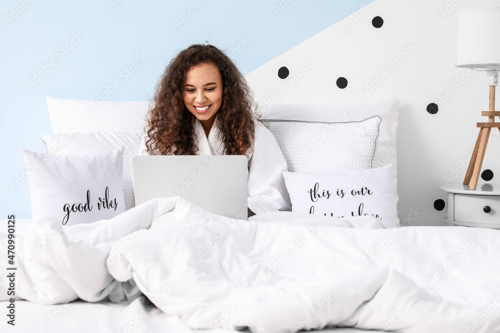 Sticker Morning of young woman with laptop sitting in bed