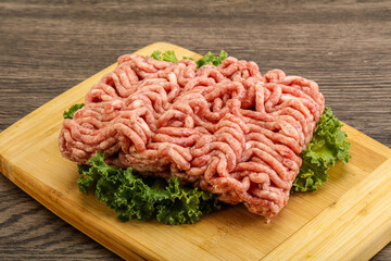 Raw pork minced meat over board