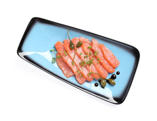 Delicious salmon carpaccio with capers, microgreens and sauce on white background, top view
