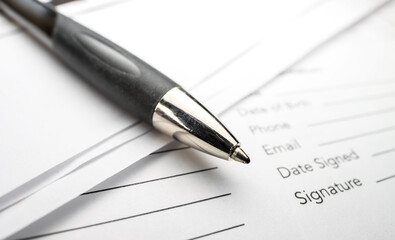 Close up shot of ball point pen on contract documents