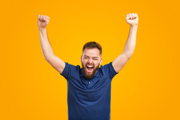 Joyful man celebrating victory and screaming