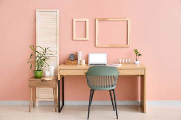 Stylish workplace in room near wall