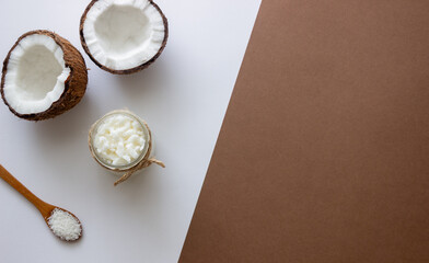 Coconut oil in a jar and fresh coconuts. Natural cosmetics.