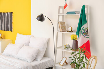 Interior of stylish bedroom with Mexican flag
