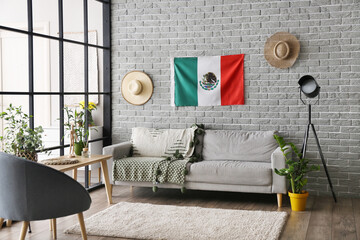 Interior of stylish room with Mexican flag on bricks wall