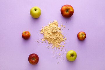 Frame made of apples and measuring scoop with protein powder on color background