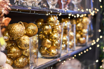 Fototapeta na wymiar golden balls. Market of decor . Lots of christmas decoration in store. Christmas shopping for new year tree.