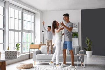 Happy interracial family dancing at home - Powered by Adobe