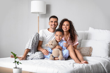 Happy interracial family in bedroom
