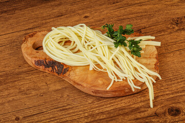 Chechil spaghetti cheese over board
