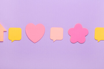 Different sticky notes on lilac background
