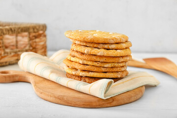 Board with delicious chocolate cookies on table